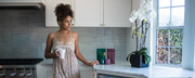 woman in kitchen looking out window - healthy diet is not enough for fertility - nutrient deficiencies in fertility
